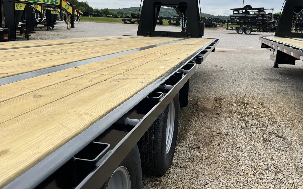 Long deckover gooseneck trailer with wood plank deck